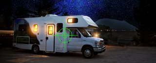 Camper van with beautiful starry sky, focus in reticle